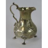 A HM silver Victorian cream jug with three cast feet, London 1874, 3.