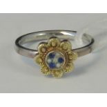 A silver and yellow metal ring,