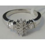 A 9ct white gold and diamond cluster ring,