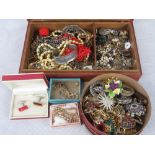 A vintage leather jewellery box containing a quantity of costume jewellery and a circular box of