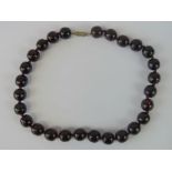 A vintage untested cherry amber type bead necklace, each 12mm, 51g.