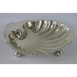 A HM silver sugar bowl of shell form on three ball feet, Chester 1920, maker Barker Bros, 2.