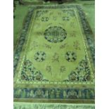 An early 20th C Oriental woollen and the silk cream ground rug having central oriental character,