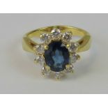 A superb 18ct gold diamond and sapphire ring, central oval Ceylon blue sapphire approx 1ct,