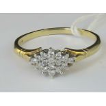 A 9ct gold diamond cluster ring, diamonds set in white metal on yellow metal shank, hallmarked 375,