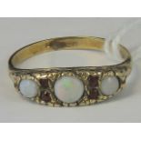 A gold opal and ruby ring,