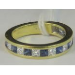 An 18ct gold diamond and sapphire half eternity ring,