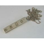 A silver ingot on silver chain, Hallmarked London 1977, 30.33g.