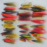 Around fifty Salmon tube flies in a three-sectional box.