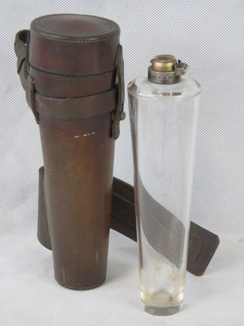 A conical glass flask in leather saddle case, top AF. 22cm high.