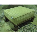 A square shaped foot stool raised over s