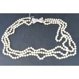 A long triple strand faux pearl necklace