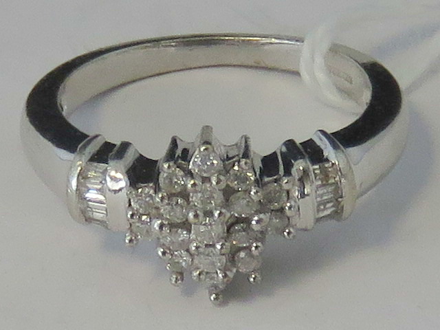 A 9ct white gold and diamond cluster rin