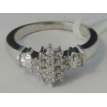 A 9ct white gold and diamond cluster rin