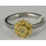 A silver and yellow metal ring, yellow m