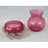 Two cranberry glass bowls.
