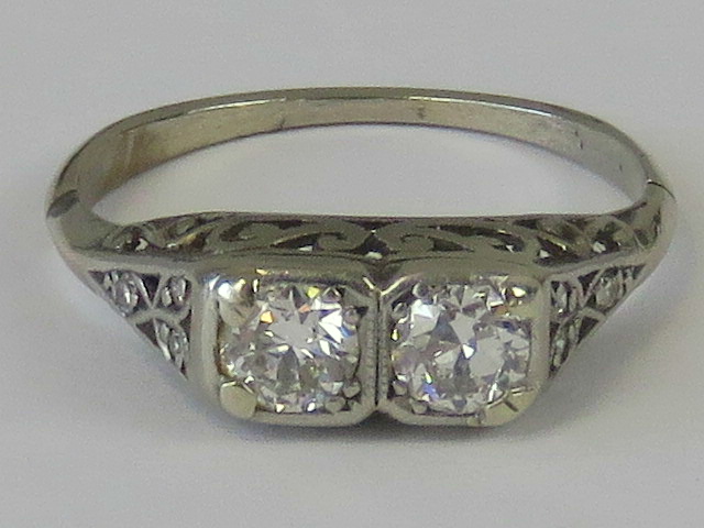 A carved head diamond ring, two 0.25ct a