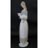 A tall Lladro figure of a lady carrying