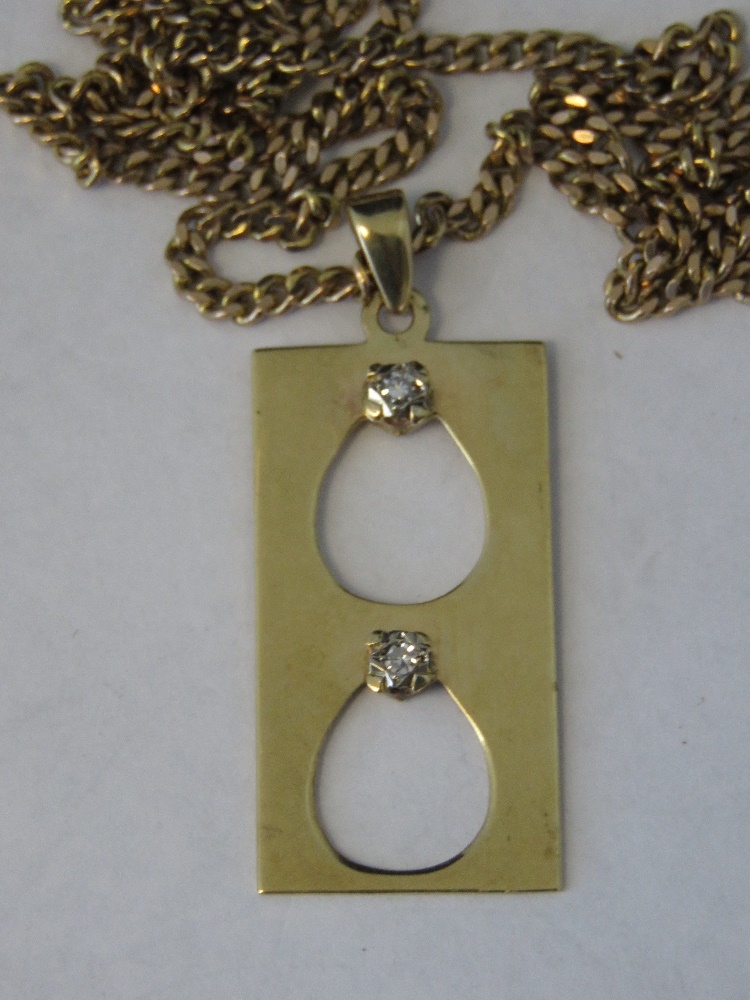 A 9ct gold rectangular pendant set with