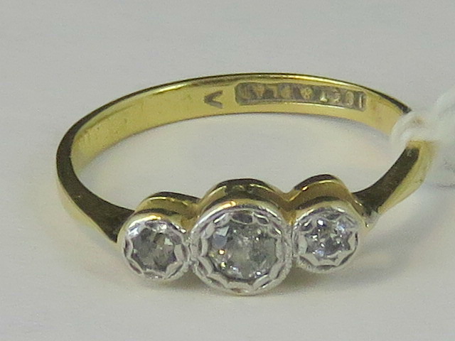 An 18ct and platinum three stone diamond