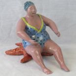 Pottery figurine of a large woman in bat