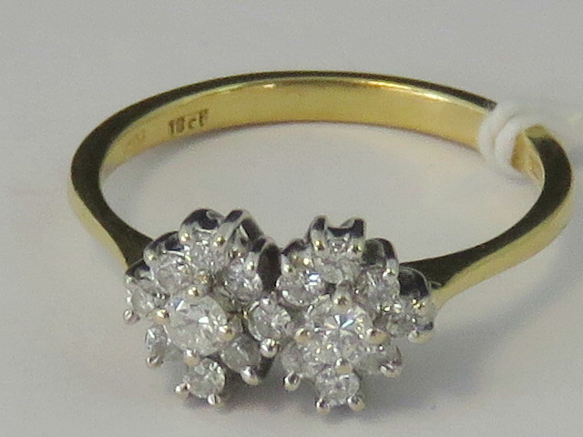 An 18ct gold diamond double cluster ring