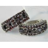 A pair of silver and garnet half hoop ea