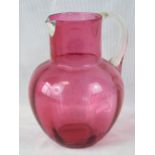 A large cranberry jug with white metal s