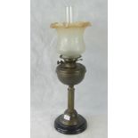 A Victorian oil lamp with glass chimney