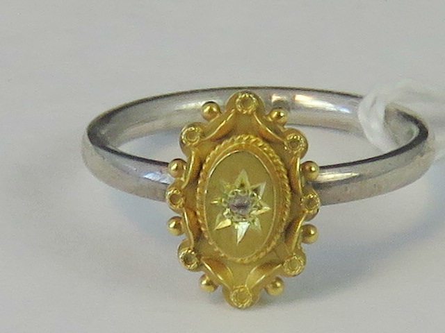 A silver and yellow metal ring, yellow m