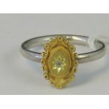 A silver and yellow metal ring, yellow m