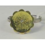 A silver and yellow metal ring, yellow m