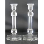 A pair of heavy glass plain candlesticks