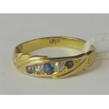 An 18ct gold diamond and sapphire ring,