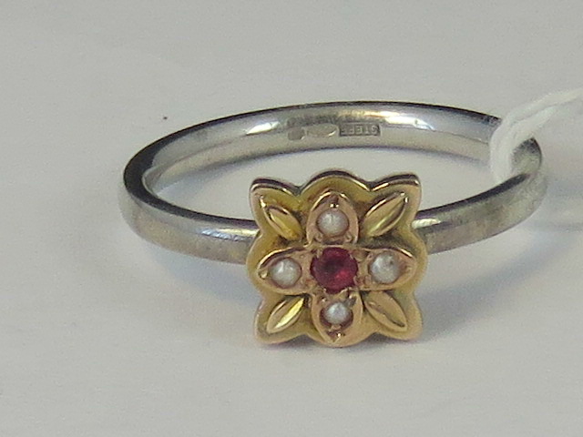 A silver and yellow metal ring, yellow m