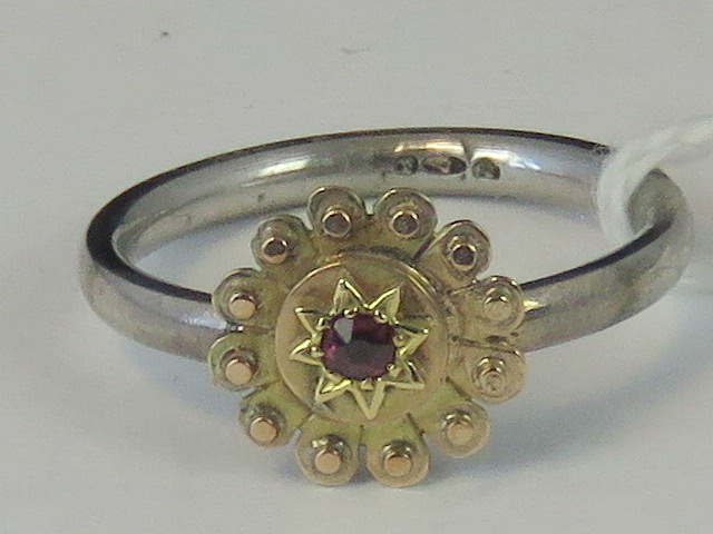 A silver and yellow metal ring, yellow m