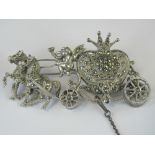 A HM silver watch within a brooch frame in the form of a marcasite encrusted heart shaped carriage