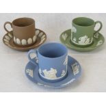 Three Wedgwood Jasper ware coffee cans and saucers in green, blue and brown.