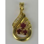 An 18ct gold ruby and diamond pendant,