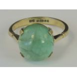 A 9ct gold green beryl ring, round cabachon of green beryl claw set in yellow metal hallmarked 375,