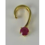 An 18ct gold and ruby pendant, round ruby of pink hue approx 0.