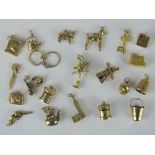 Twenty-one 9ct gold charms; windmill, thimble, two postboxes, cupid, Big Ben, Rings, scissors,