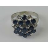 A 14ct white gold Ceylon blue sapphire and diamond cluster ring, three tiers of round sapphires,