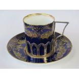 A Staffordshire bone china coffee can and saucer with silver sleeve hallmarked London 1916,