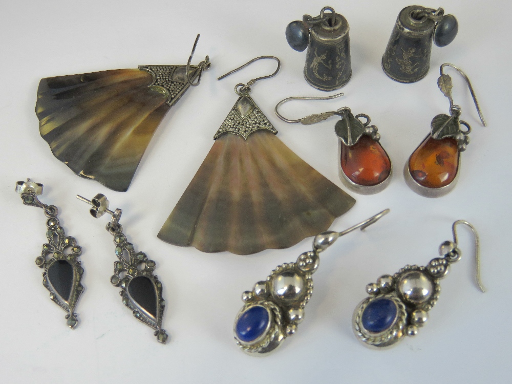 Five pairs of silver and white metal earrings; a pair of Stirling Siam niello bells,