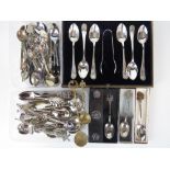 A boxed set of plated teaspoons and sugar tongs,