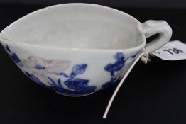 A BLUE AND WHITE SAUCE BOAT WITH RAISED FLORAL DECORATION AND SIX CHARACTER MARK UNDERFOOT.