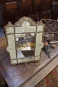 AN 18TH.C.EMBOSSED LEATHER FRAME AND METAL THREAD EMBROIDERED PANEL EASEL MIRROR