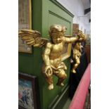 A PAIR OF ANTIQUE CARVED GILTWOOD LARGE WINGED CHERUBS