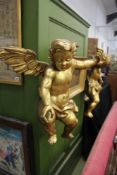 A PAIR OF ANTIQUE CARVED GILTWOOD LARGE WINGED CHERUBS